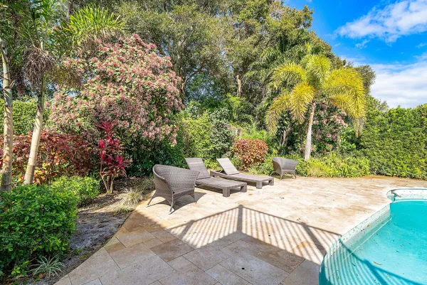 a kitchen with granite countertop white cabinets stainless steel appliances and window