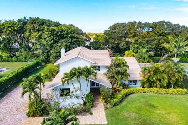 a large kitchen with stainless steel appliances a large counter top a stove and a refrigerator