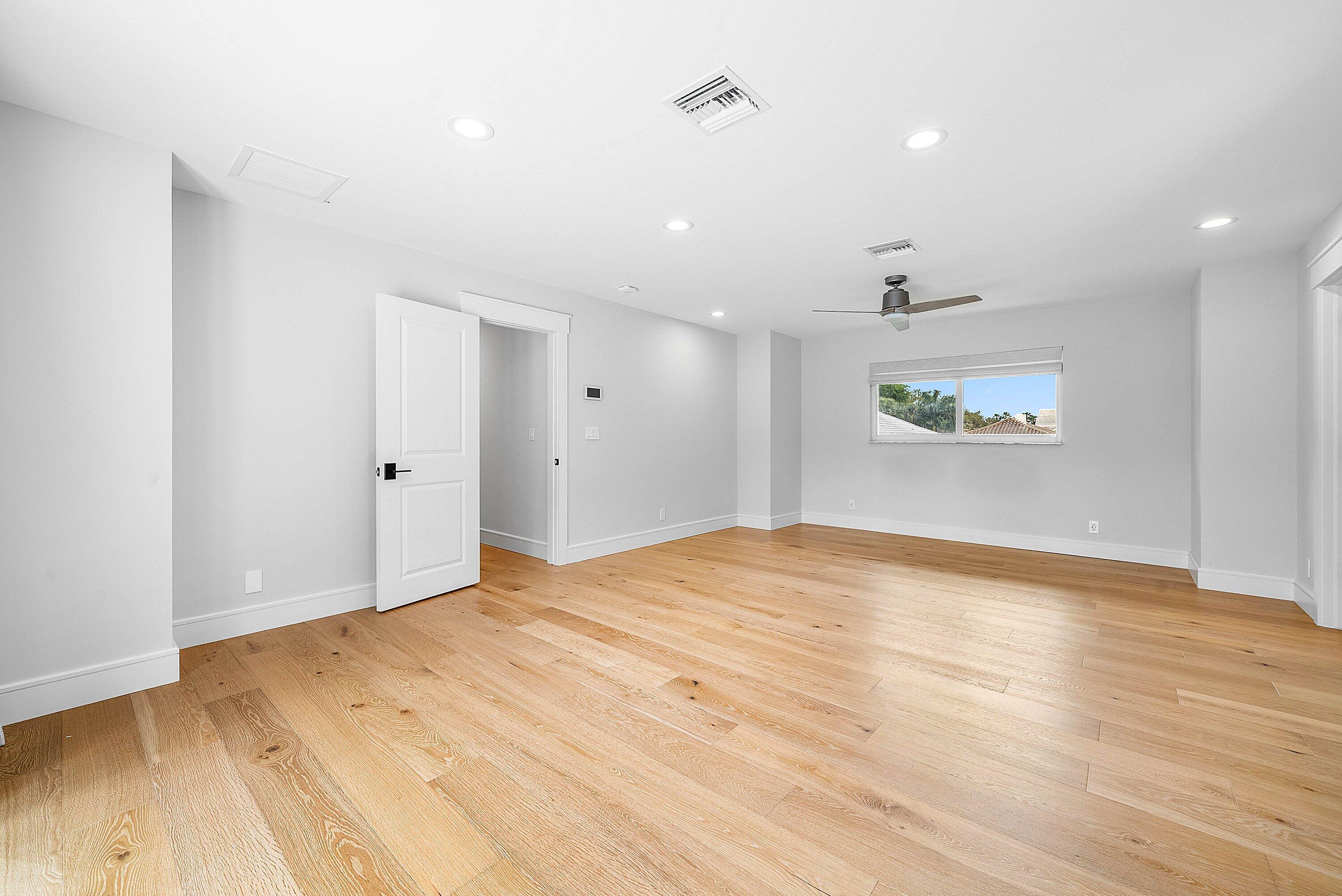 10893 Gleneagles Road Boynton Beach, FL 33436 - Photo 56 of 134 a view of empty room with wooden floor and fan