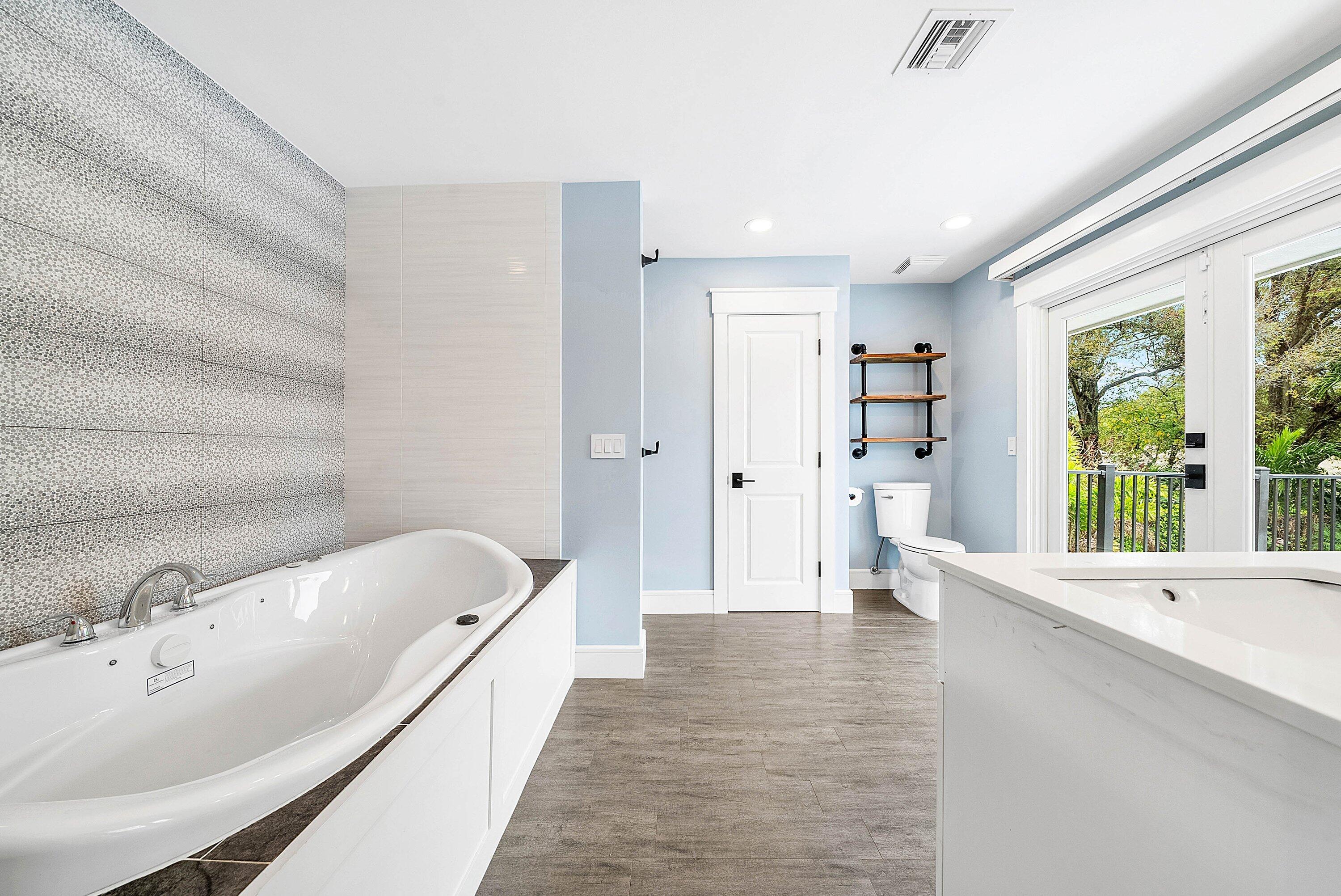 10893 Gleneagles Road Boynton Beach, FL 33436 - Photo 60 of 134 a bathroom with a tub a sink and a large window