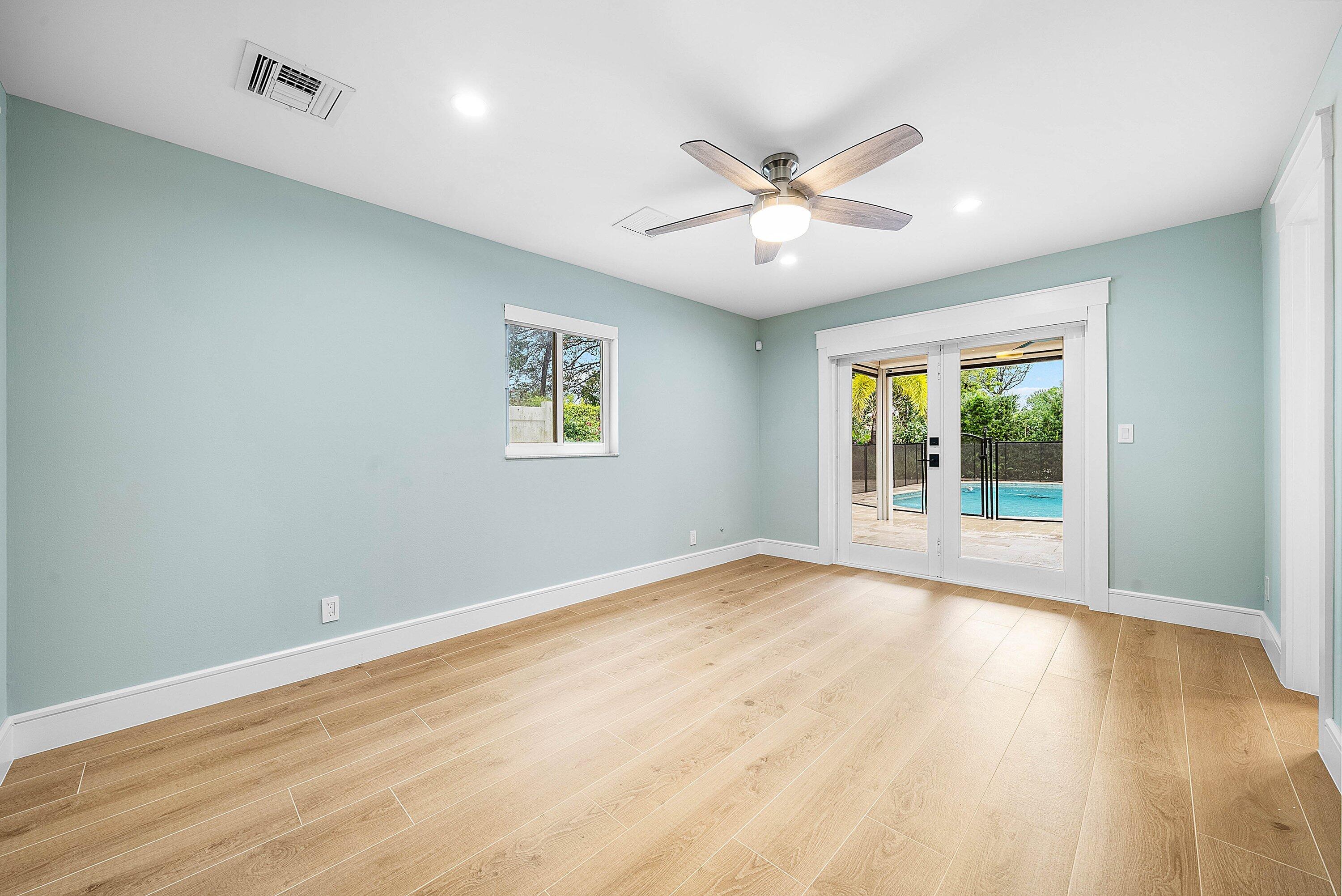 10893 Gleneagles Road Boynton Beach, FL 33436 - Photo 62 of 134 a view of an empty room with wooden floor and a window