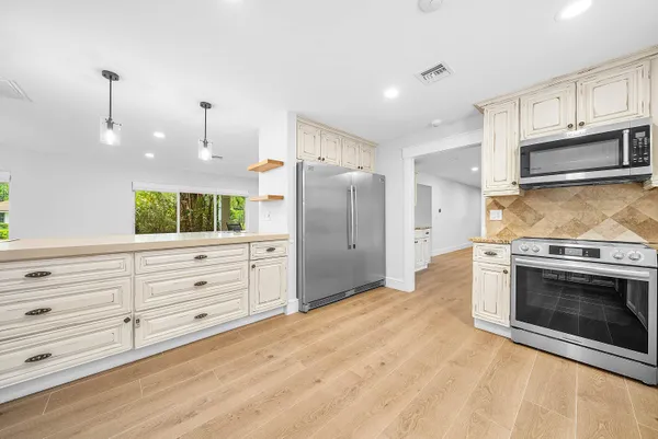 a view of backyard with a table and chairs and potted plants