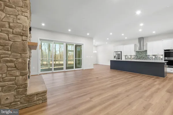 a view of a livingroom with wooden floor and front door