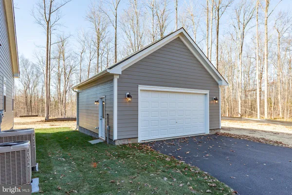 a view of a house with a yard and garage