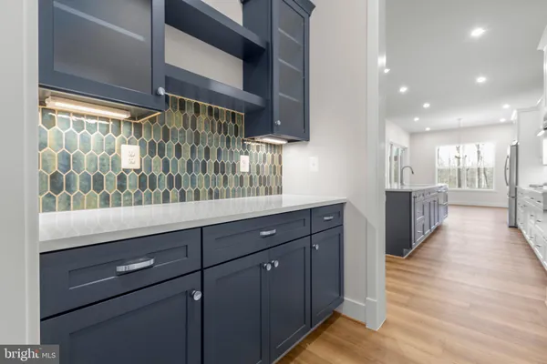 a large kitchen with kitchen island a sink counter space stainless steel appliances and cabinets