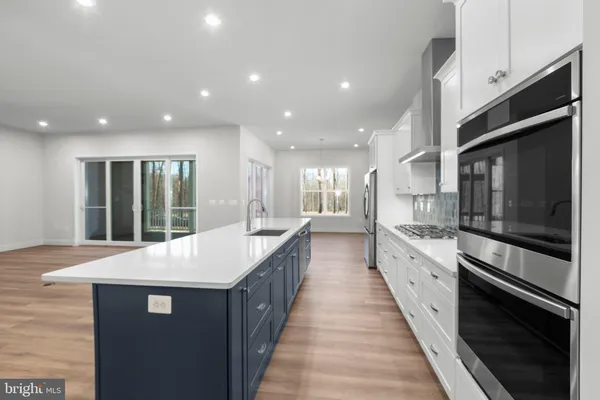 a kitchen with a stove a sink and a microwave