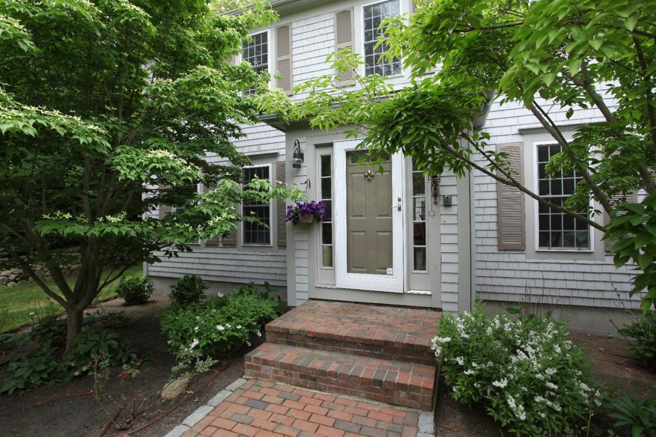 693 Great Neck Road South Mashpee, MA 02649 - Photo 3 of 23 a front view of a house with a garden