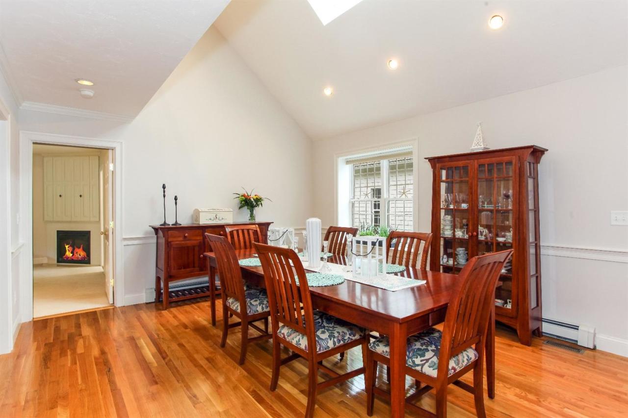 693 Great Neck Road South Mashpee, MA 02649 - Photo 8 of 23 a view of a dining room with furniture and wooden floor