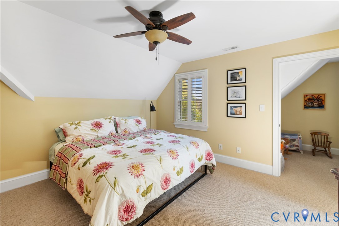 8947 Cherokee Road Richmond, VA 23235 - Photo 29 of 45 a bedroom with a bed dresser and a window