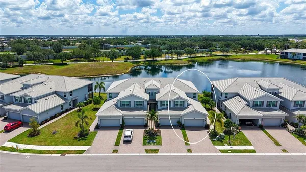 an aerial view of a house with a lake view