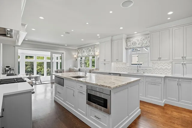 a kitchen with a stove sink and cabinets