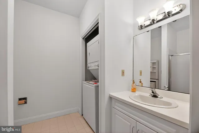 a bathroom with a granite countertop toilet and a shower