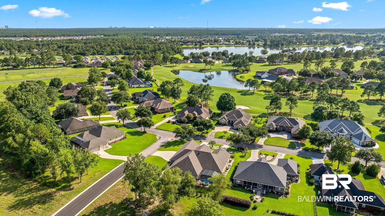 23357 Carnoustie Drive Foley, AL 36535 - Photo 97 of 99 Aerial perspective of suburban area featuring a large body of water and a local golf course