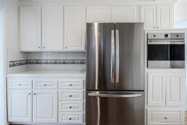 a kitchen with cabinets and stainless steel appliances