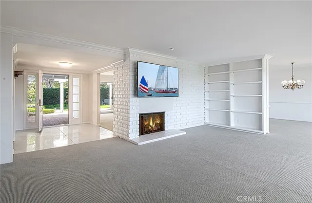 a view of a livingroom with an empty space and a fireplace