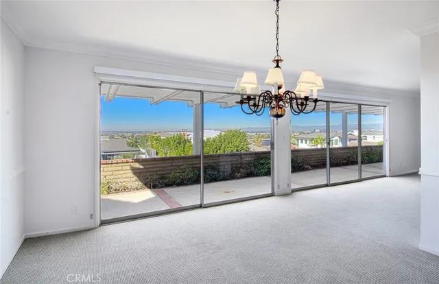 a view of a dining room with a chandelier and living room view