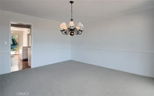 a view of a chandelier in big room and chandelier
