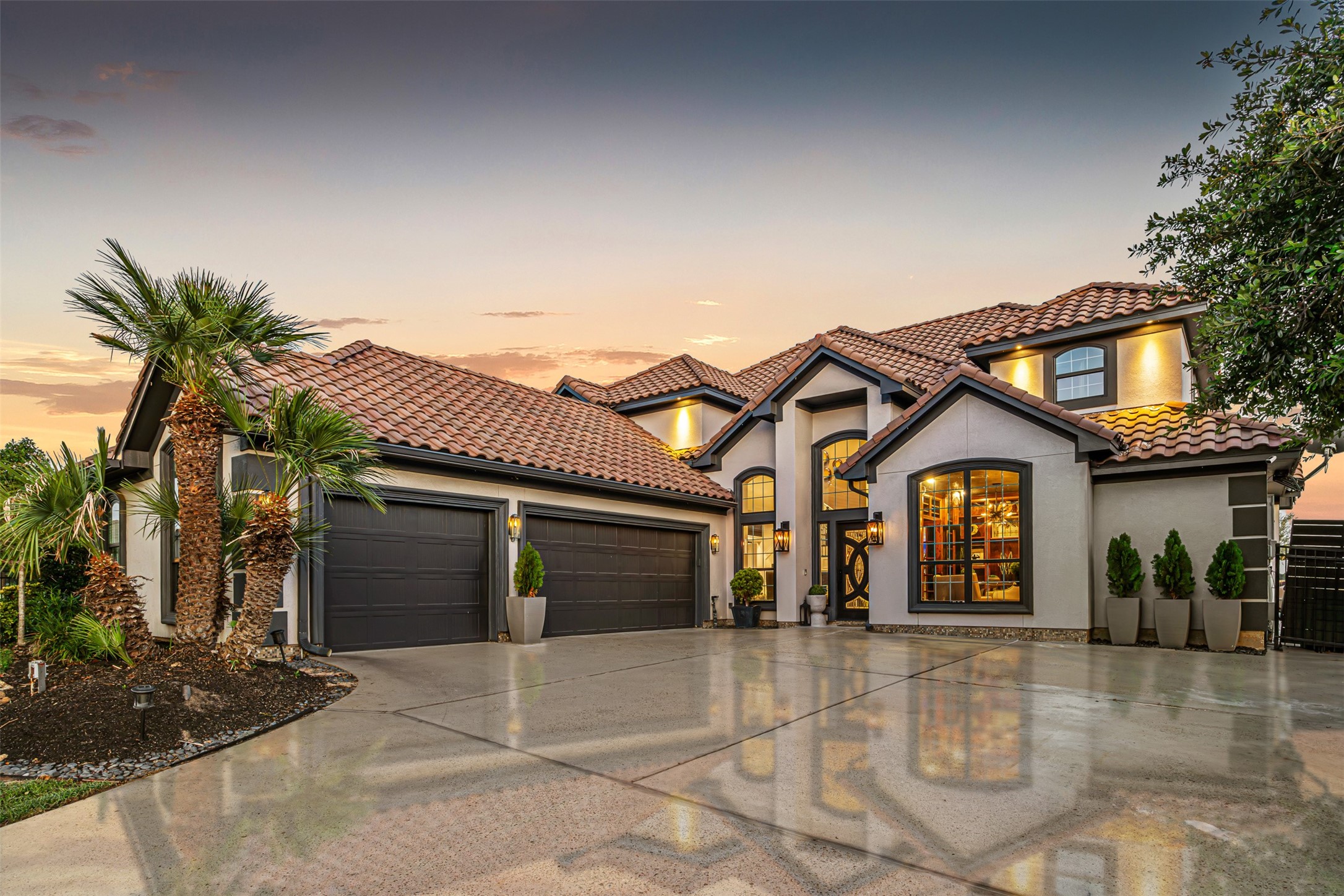12345 White Oak Point Conroe, TX 77304 - Photo 1 of 50 a view of a white house with a large space and palm trees