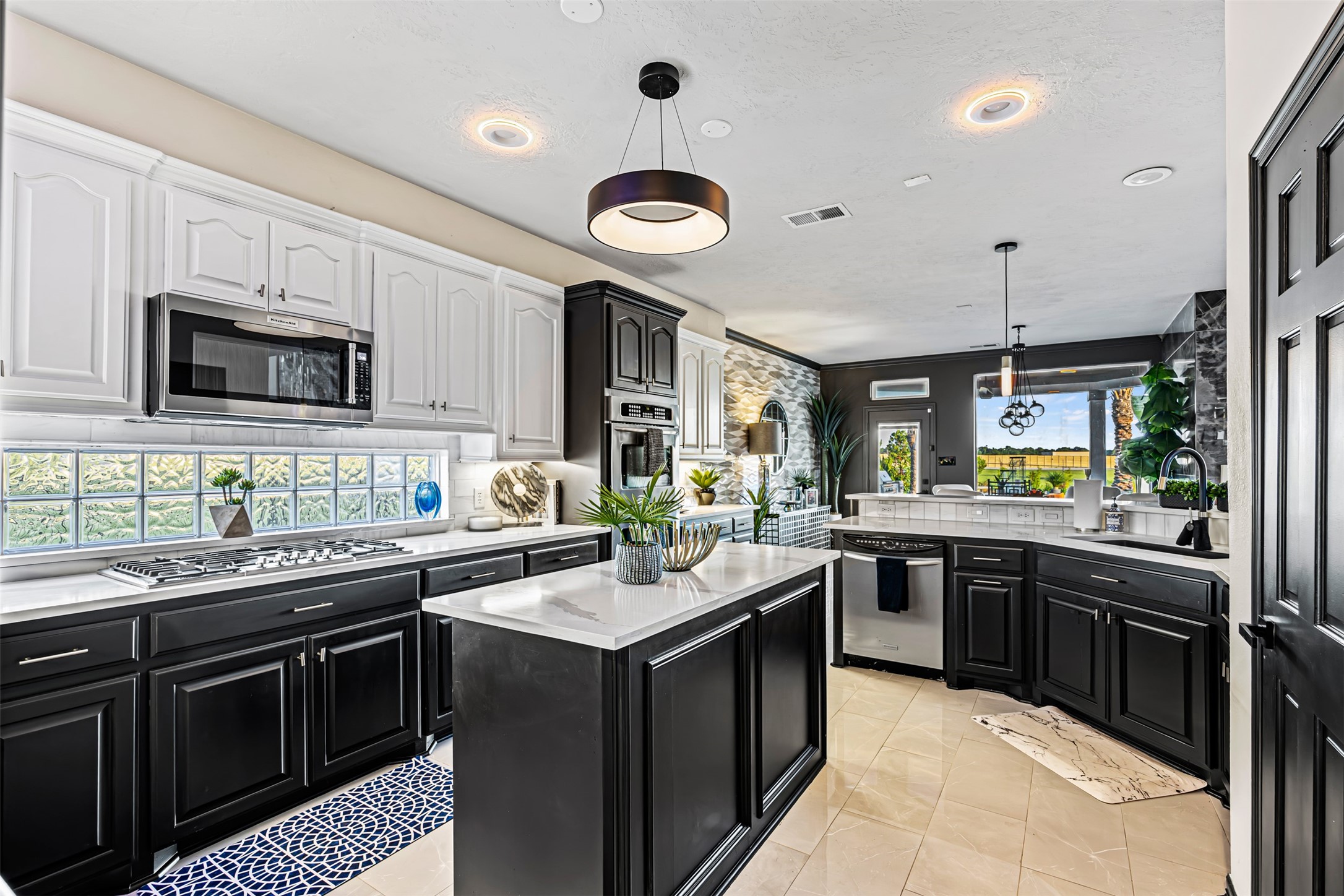 12345 White Oak Point Conroe, TX 77304 - Photo 22 of 50 a kitchen with a sink stove a oven and a microwave