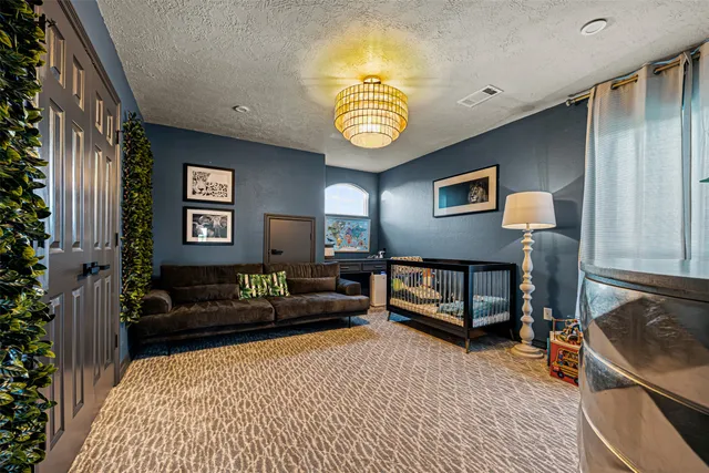 a spacious bedroom with a bed a couch and a window