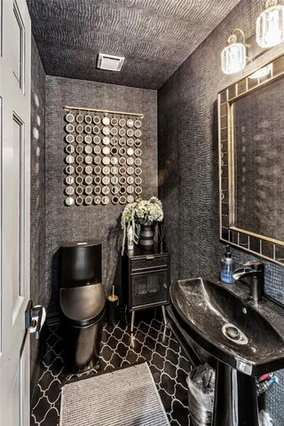 a spacious bathroom with a granite countertop sink and a mirror