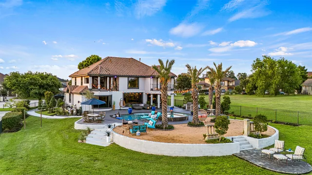 a aerial view of a house with garden space and lake view