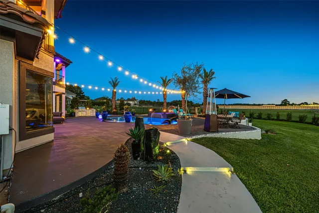 a view of a house with sitting area and swimming pool