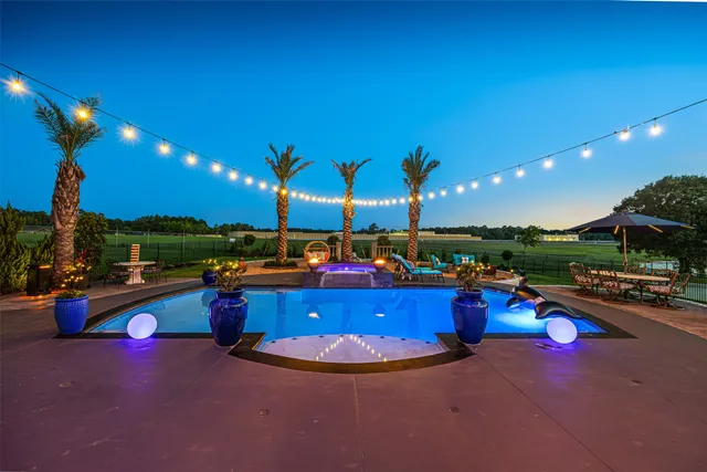 a swimming pool with outdoor seating and yard