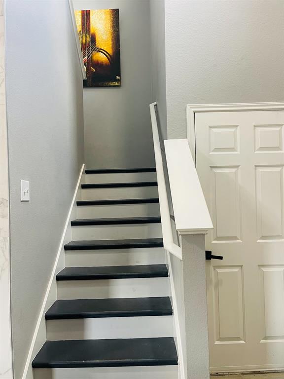516 Angela Lane Euless, TX 76039 - Photo 21 of 39 Stairway with a textured wall