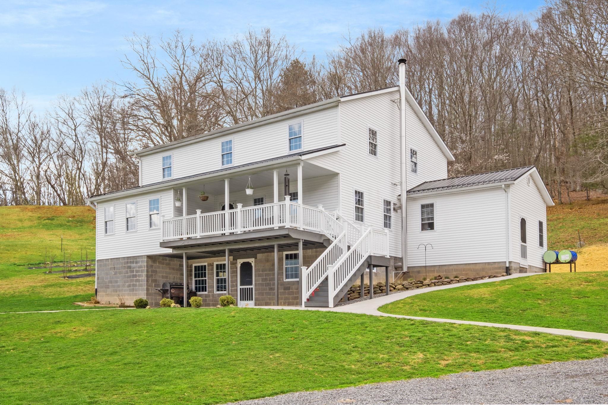 3356 Jackson River Road Monterey, VA 24465 - Photo 3 of 72 a view of a white house with a big yard and large trees