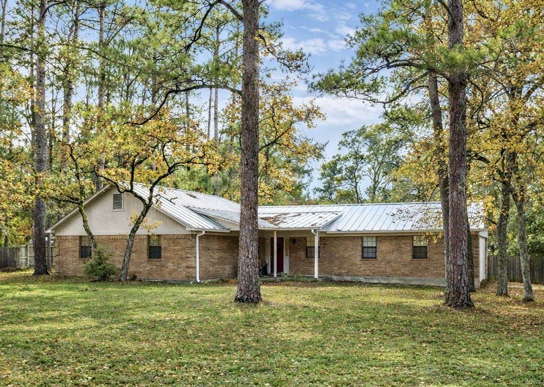 326 Pine View Loop Bastrop, TX 78602 - Photo 2 of 29 Ranch-style house with a metal roof, brick siding, and a porch