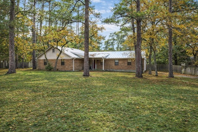 326 Pine View Loop Bastrop, TX 78602 - Photo 29 of 29 Ranch-style house featuring a metal roof and brick siding