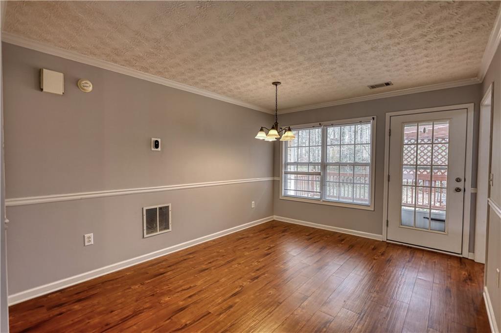 1006 English Oak Lane Winder, GA 30680 - Photo 11 of 83 a view of an empty room with a window and wooden floor