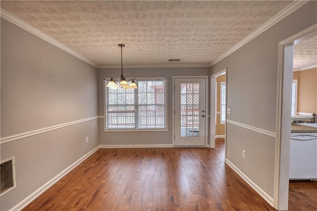 1006 English Oak Lane Winder, GA 30680 - Photo 12 of 83 a view of an empty room with window and wooden floor