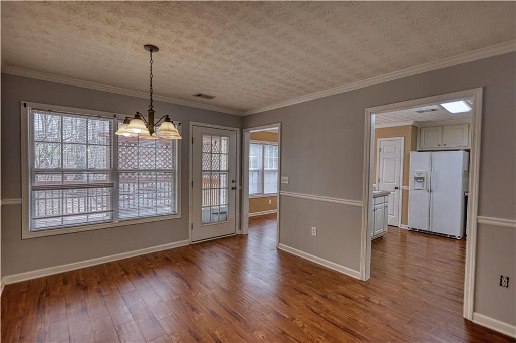 1006 English Oak Lane Winder, GA 30680 - Photo 13 of 83 a view of an empty room with wooden floor and a window