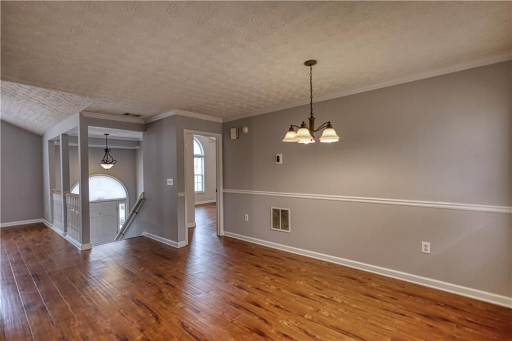 1006 English Oak Lane Winder, GA 30680 - Photo 14 of 83 a view of a room with wooden floor and chandelier