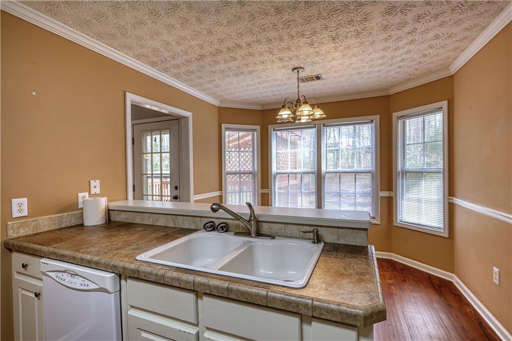 1006 English Oak Lane Winder, GA 30680 - Photo 17 of 83 a view of a kitchen with granite countertop a sink and a stove