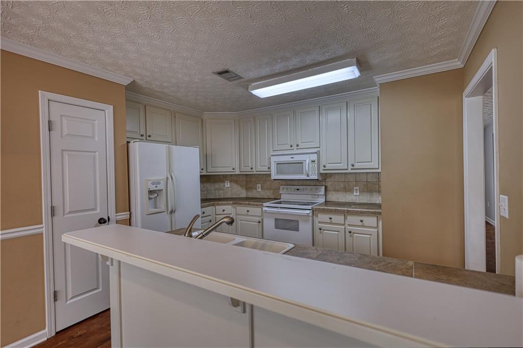 1006 English Oak Lane Winder, GA 30680 - Photo 20 of 83 a kitchen with refrigerator cabinets and stove top oven