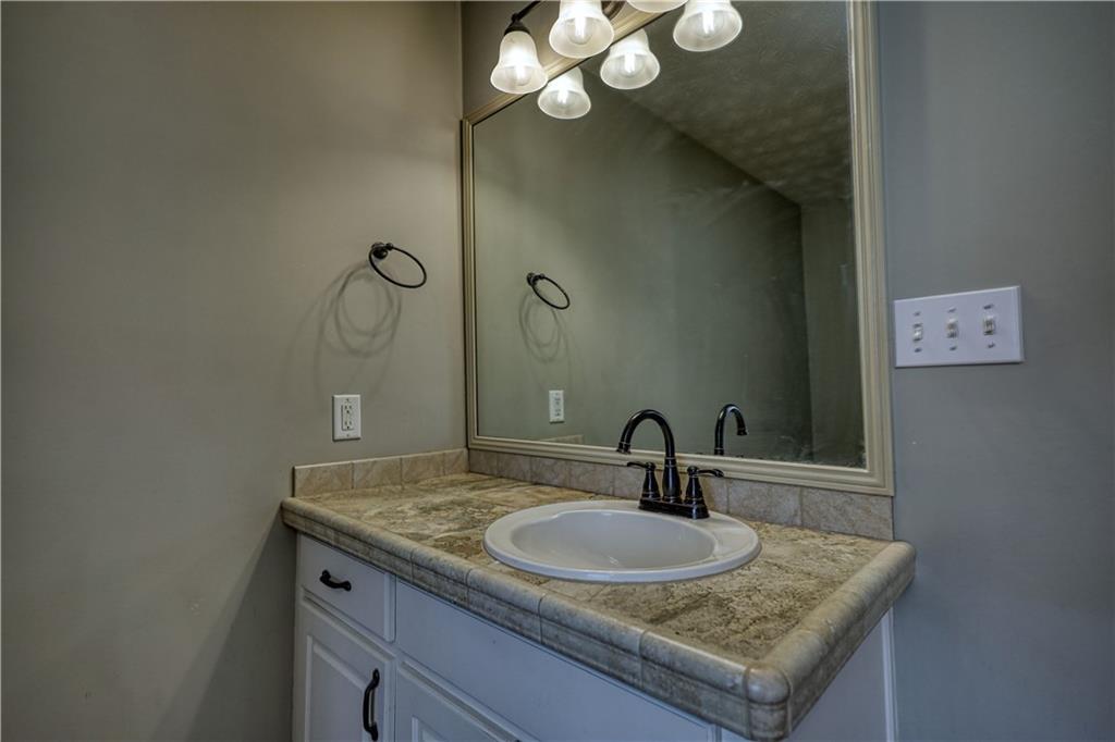 1006 English Oak Lane Winder, GA 30680 - Photo 31 of 83 a bathroom with a sink and a mirror