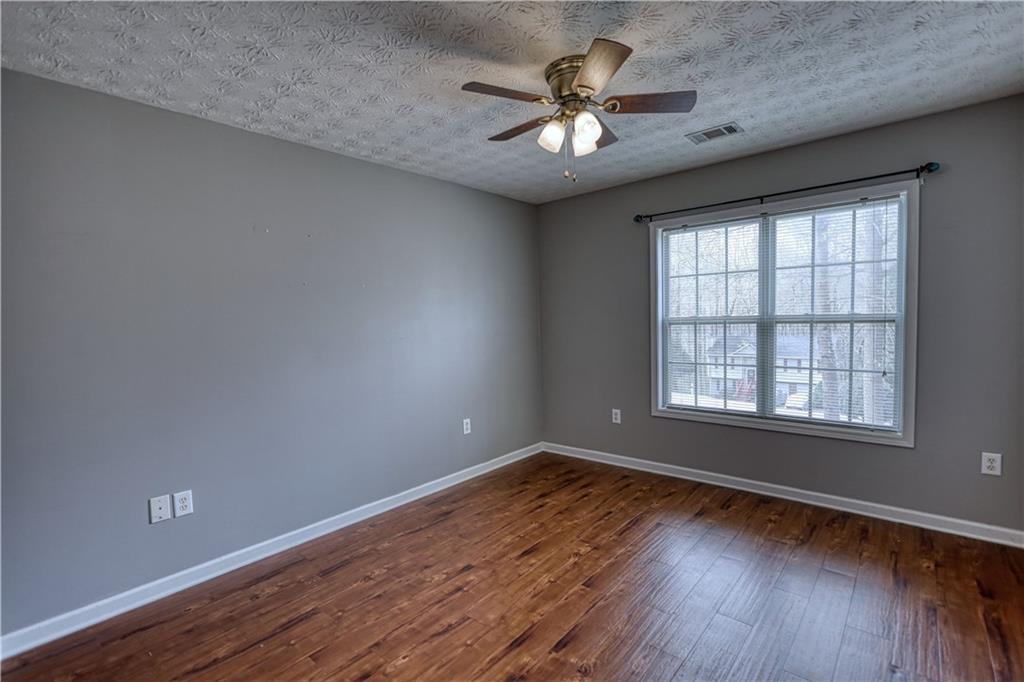 1006 English Oak Lane Winder, GA 30680 - Photo 33 of 83 an empty room with wooden floor and windows