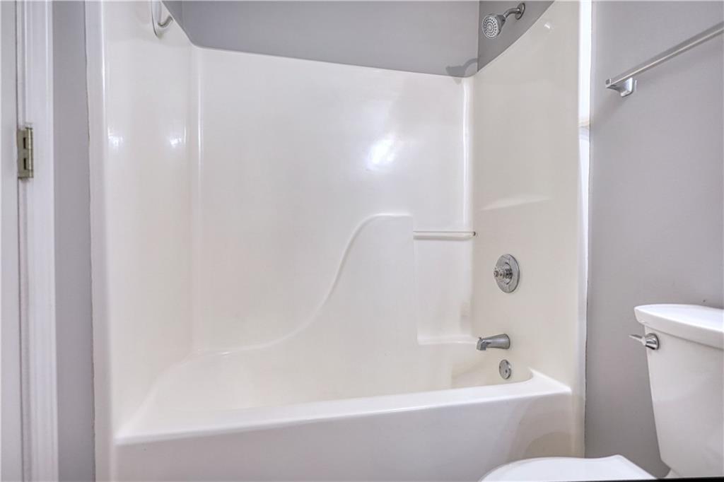 1006 English Oak Lane Winder, GA 30680 - Photo 37 of 83 a bathroom with a bathtub and a toilet
