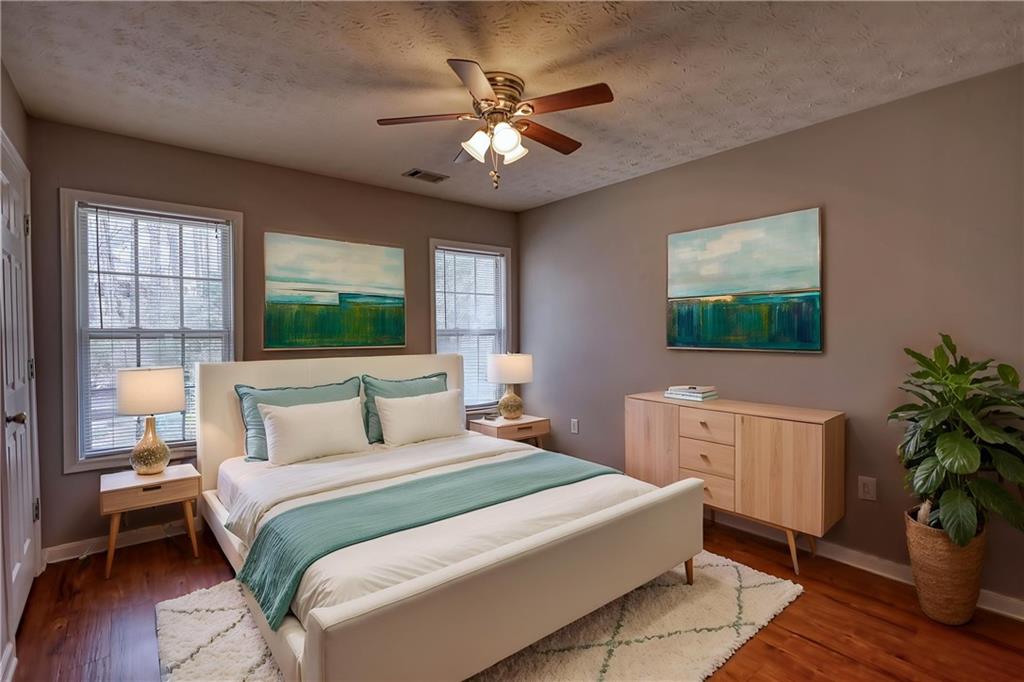 1006 English Oak Lane Winder, GA 30680 - Photo 38 of 83 a bedroom with a large bed and a chandelier