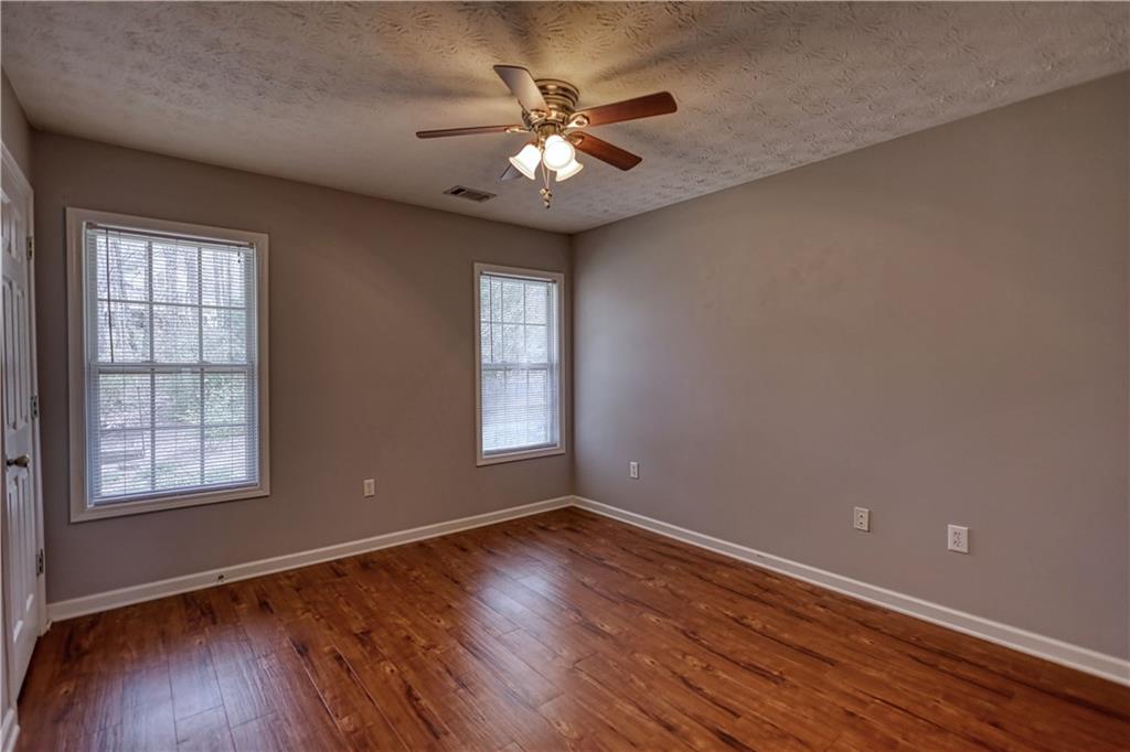 1006 English Oak Lane Winder, GA 30680 - Photo 39 of 83 a view of an empty room with wooden floor and a window