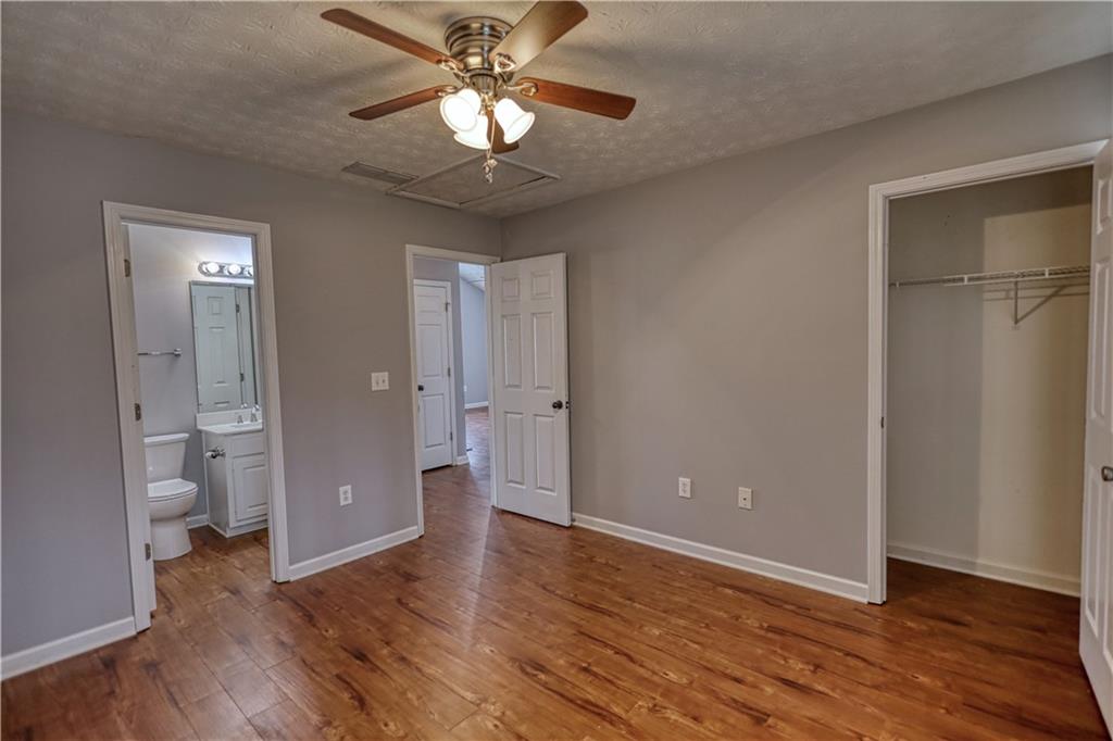 1006 English Oak Lane Winder, GA 30680 - Photo 40 of 83 wooden floor in an empty room with a bathroom