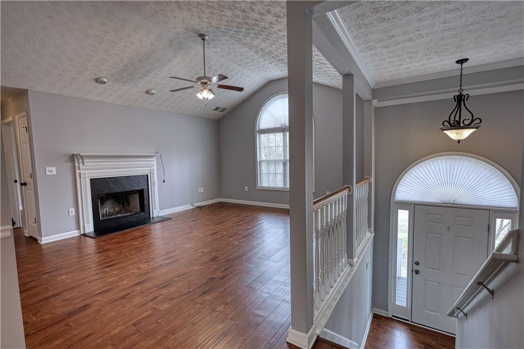 1006 English Oak Lane Winder, GA 30680 - Photo 4 of 83 a view of an empty room with wooden floor fireplace and a window