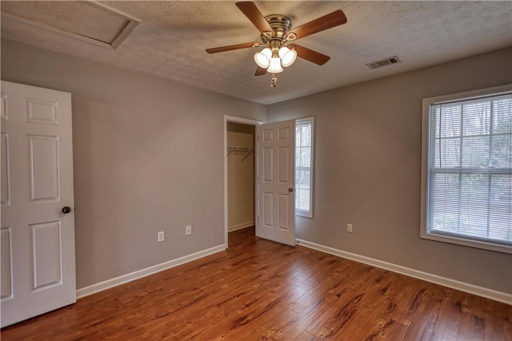 1006 English Oak Lane Winder, GA 30680 - Photo 41 of 83 wooden floor in an empty room with a window
