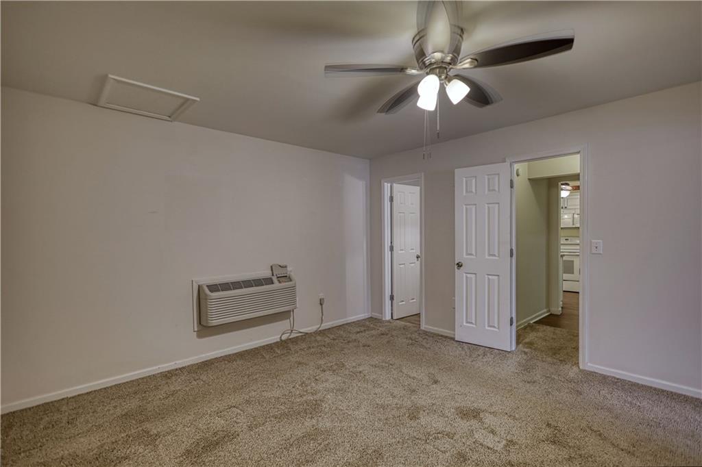 1006 English Oak Lane Winder, GA 30680 - Photo 48 of 83 an empty room with closet and ceiling fan