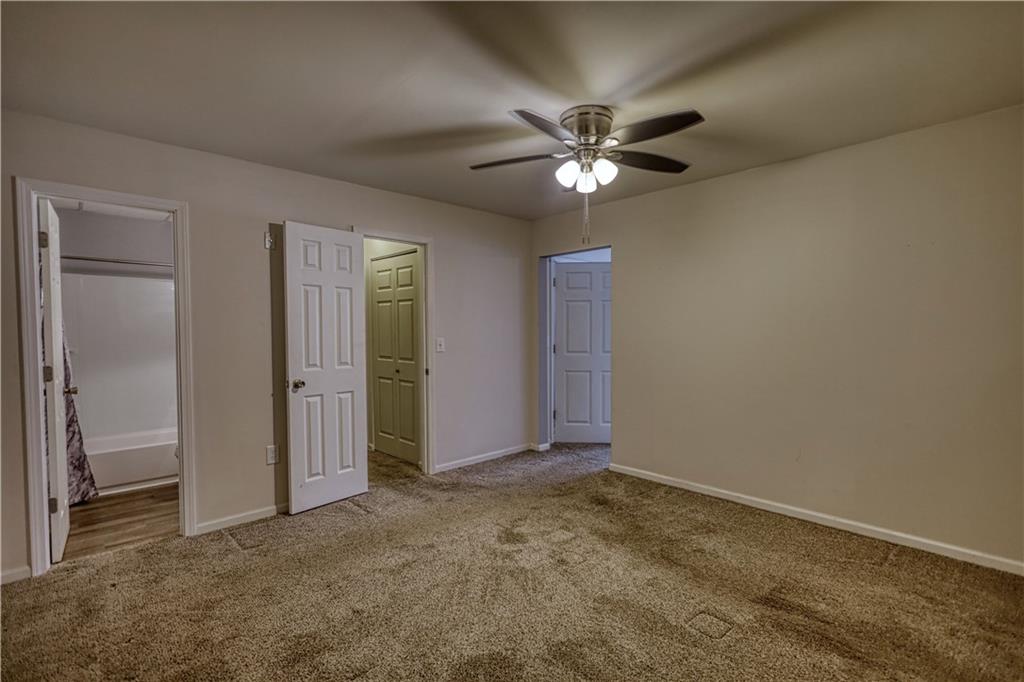 1006 English Oak Lane Winder, GA 30680 - Photo 49 of 83 an empty room with closet and a chandelier fan