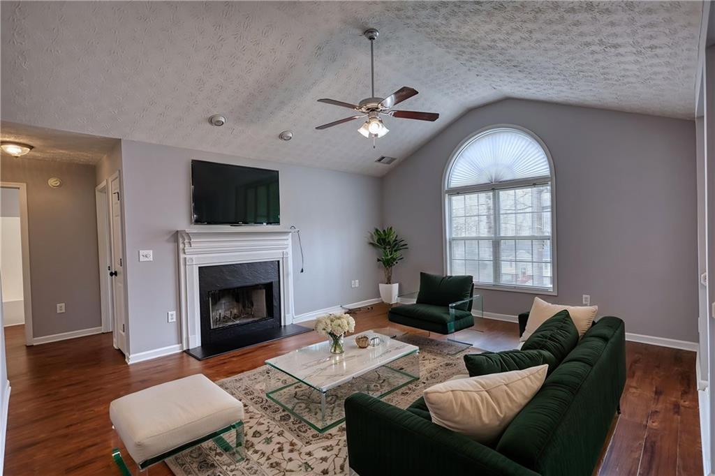 1006 English Oak Lane Winder, GA 30680 - Photo 5 of 83 a living room with furniture a fireplace and a flat screen tv