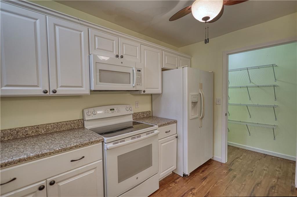 1006 English Oak Lane Winder, GA 30680 - Photo 57 of 83 a kitchen with granite countertop cabinets stainless steel appliances and a counter space